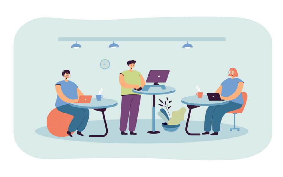 Office employees working at ergonomic workplaces